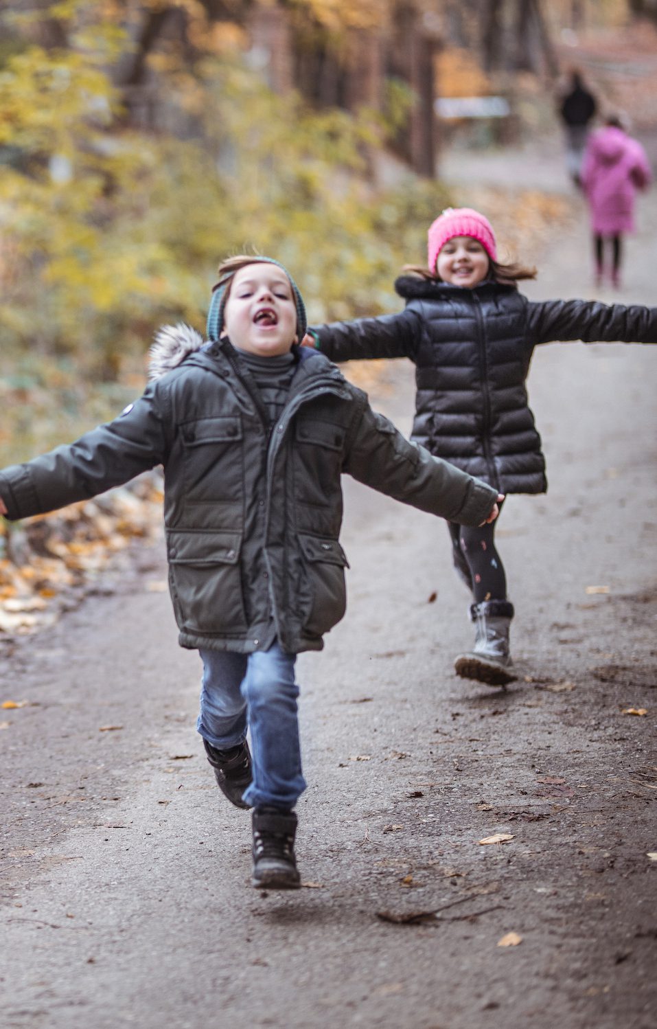 Happy cheerful kids playing. Kids have fun running in nature, fall time