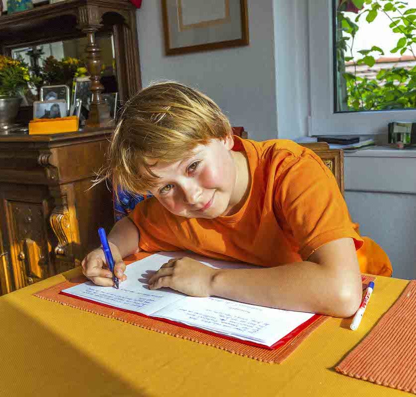 homework young boy doing homework at the table