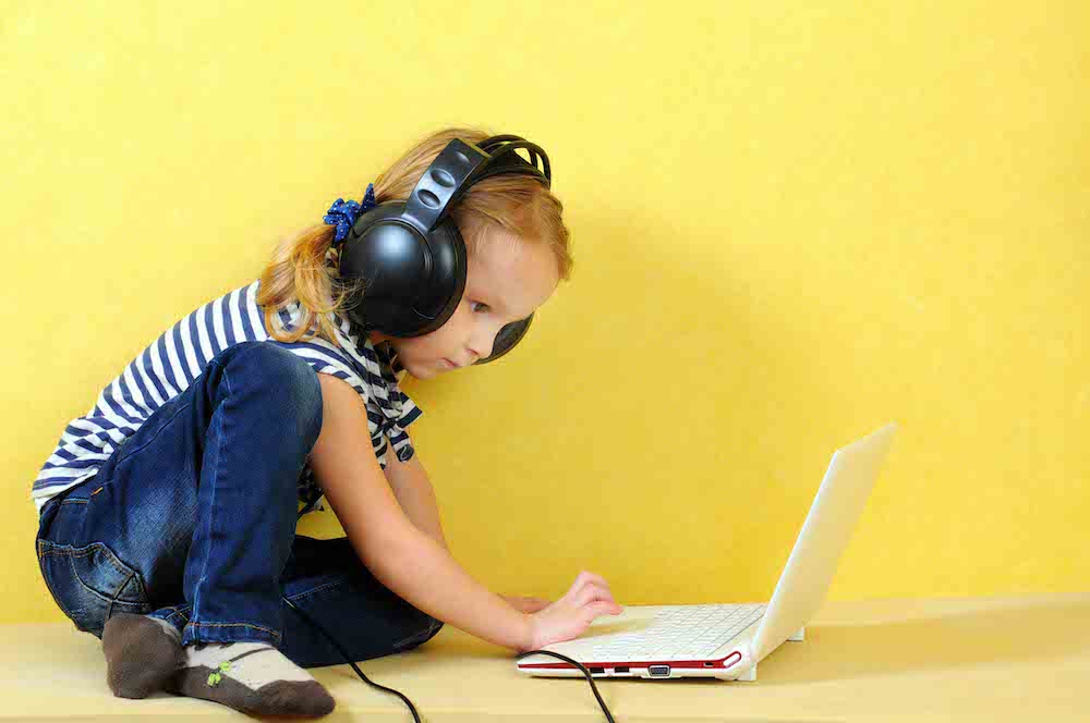 girl-laptop young girl on a laptop with headphones
